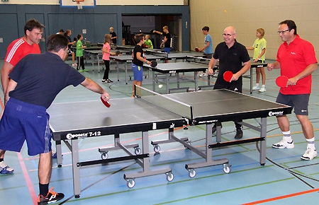 Abteilungsleiter Martin Reichert und Frank Tatzel (l.) sowie Schulleiter Norbert Giesen und Sparkassenvorstand Frank-Rainer Laake (r.) spielen sich an einer der neuen Tischtennis-Platten warm.