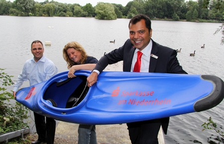 Harald Berghoff, seine Frau Simone und Giovanni Malaponti mit dem Kanupolo-Boot, dass die Sparkasse am Niederrhein dem WSV Moers gespendet hat.