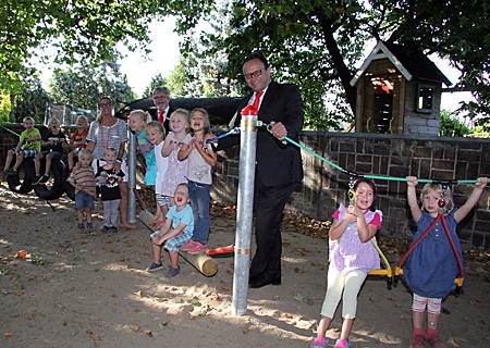 Sparkassenvorstand Frank-Rainer Laake (vorne) und Geschäftsstellenleiter Heinz Geßmann besuchten den katholischen Kindergarten in Ossenberg. Kita-Leiterin Katja Vespermann und die Kinder zeigten, wie gut man auf dem neuen Klettergerüst klettern und krabbeln kann.  