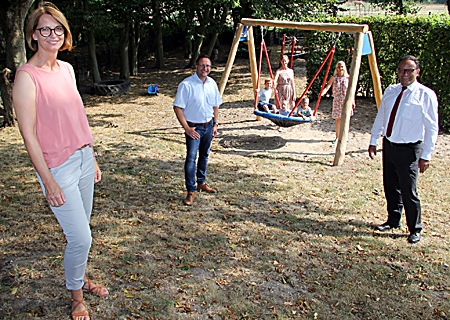 Lennard, Johanna und Mika (hinten, von links) zeigten, was die neue Nestschaukel kann. Ihre Mütter, Kerstin Gerards (links) und Carmen Müser, schaukelten an. Bürgermeister Thomas Goertz (links) und Sparkassenvorstand Frank-Rainer Laake erfuhren von Kita-Leiterin Britta Köhn (ganz links), dass die Kinder gut mit den Einschränkungen der vergangenen Monate klar gekommen seien.