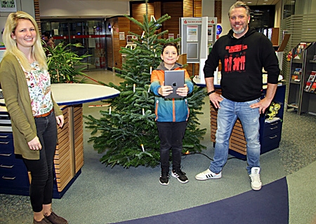 In der Sparkassen-Geschäftsstelle in Borth erhielt Mads seinen Gewinn: ein nagelneues iPad. Die stellvertretende Leiterin Eva Gräfe und Vater Andreas freuten sich mit ihm.  