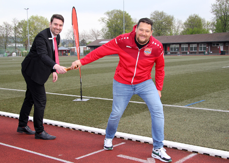 Geschäftsstellenleiter Markus Hans (l.) übergibt einen Staffelstab an Sportwart und Lauftrainer René Niersmann. Die Sparkasse am Niederrhein unterstützt zwei Leichtathletik-Meetings, bei denen am Wochenende 6. und 7. Mai bis zu 250 Mehrkämpfer und Läufer im Willy-Lemkens-Sportpark des SV Sonsbeck erwartet werden.